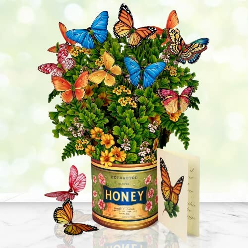 Colorful butterflies on flowers in a honey can vase.