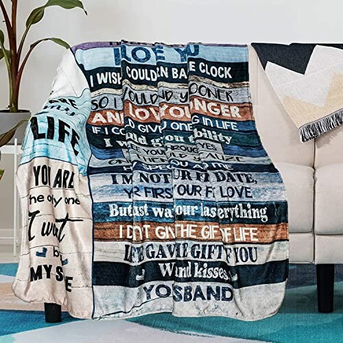 Cozy blanket with inspirational quotes draped over a couch.