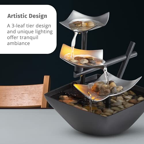 A three-tier tabletop water fountain with rocks and ambient lighting.